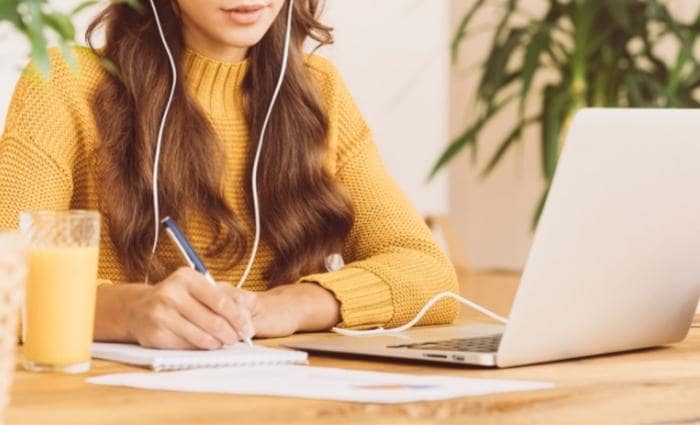 woman sitting at a desk taking an online course