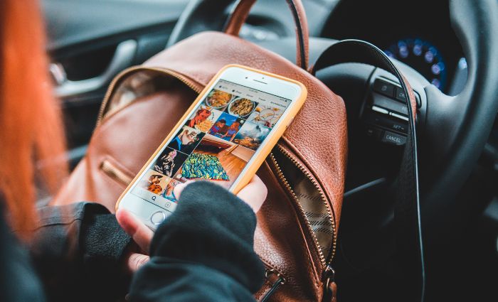 woman looking at a social media feed on her phone