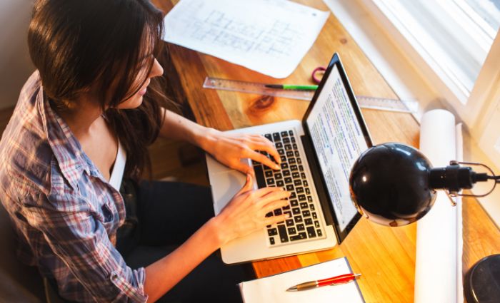 Woman writing text on a computer