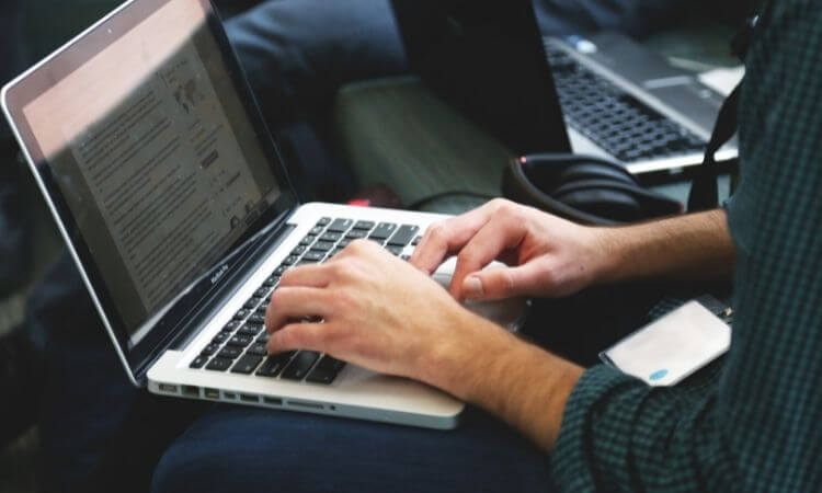 freelancer typing on a computer