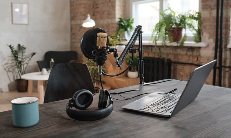 Podcast equipment setup on a desk with computer