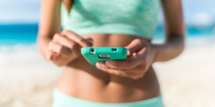 Woman holding phone with fitness app