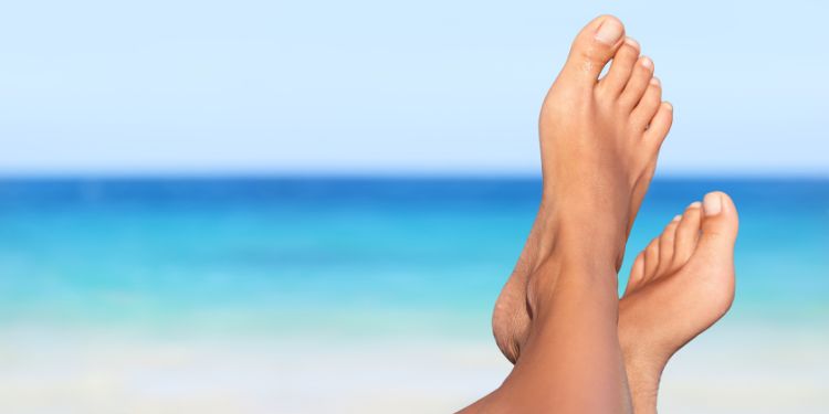 feet propped up at the beach