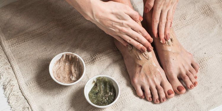 person scrubbing their feet