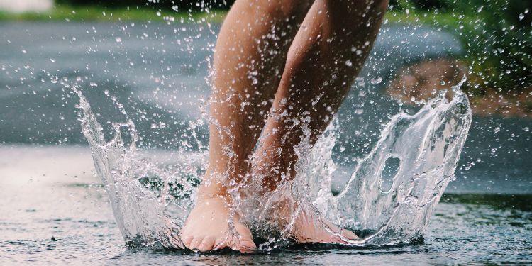 feet splashing in a puddle