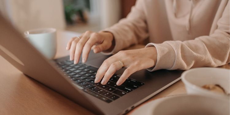 woman typing on a computer as a freelance writer