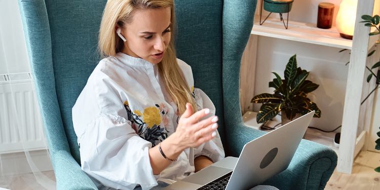 woman doing online coaching on her computer at home