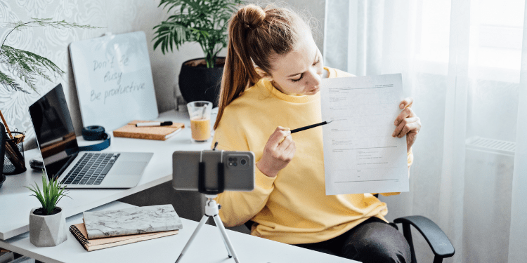 woman filming herself teaching as a side hustle