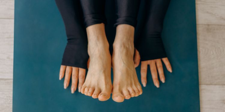 hands and feet on a yoga mat