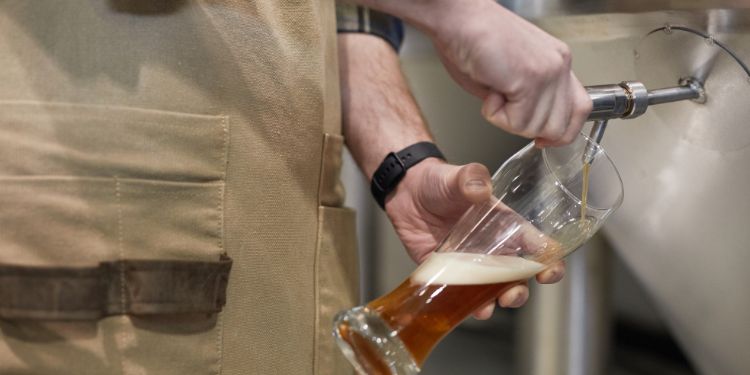 brewmaster pouring a draft beer