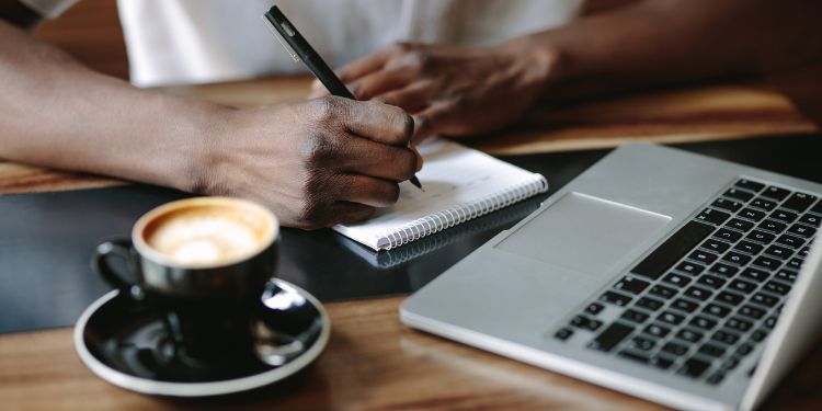 taking notes at a coffee shop