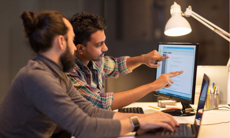 two men collaborating creatively at a computer